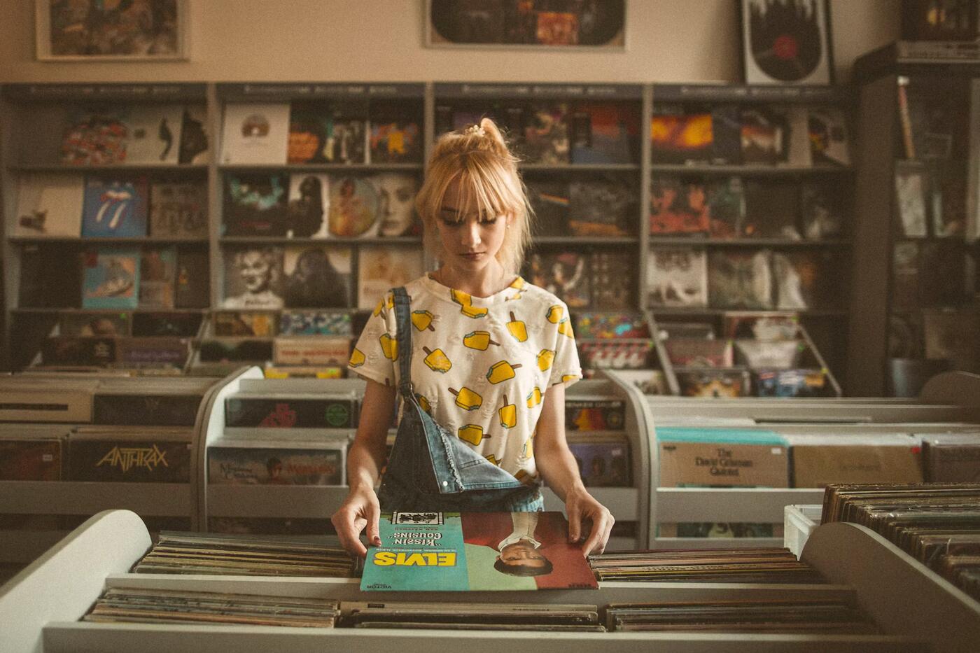 A woman browsing vinyl records in a record shop